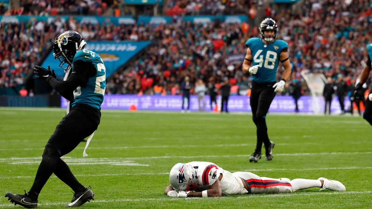 Jaguars cornerback Ronald Darby celebrates as Patriots wide receiver Ja'Lynn Polk reacts after slipping and not catching a two-point conversion attempt during the fourth quarter.