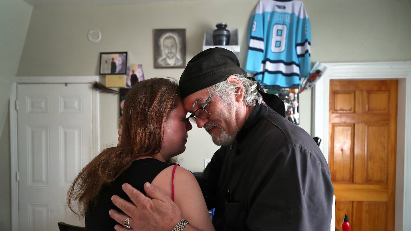 Arthur Barnard embraced his daughter-in-law, Kristy Strout, in her kitchen where she has a memorial for her late husband and Arthur’s son, Artie Strout. Artie Strout was killed while playing pool at Schemengees Bar & Grille last October during a mass shooting in Lewiston, Maine.