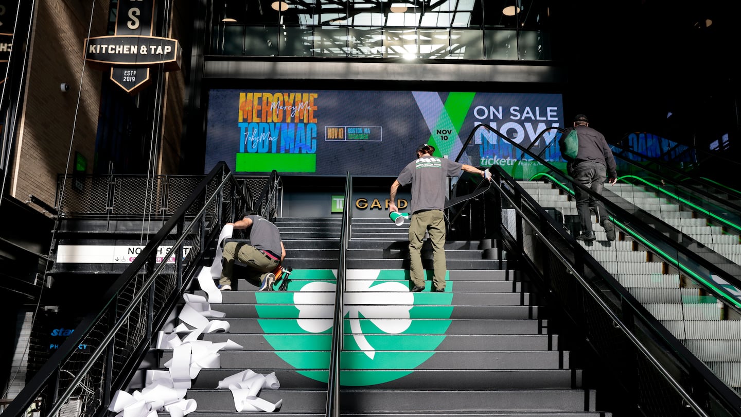 Workers put the finishing touches on the steps outside TD Garden on Monday.