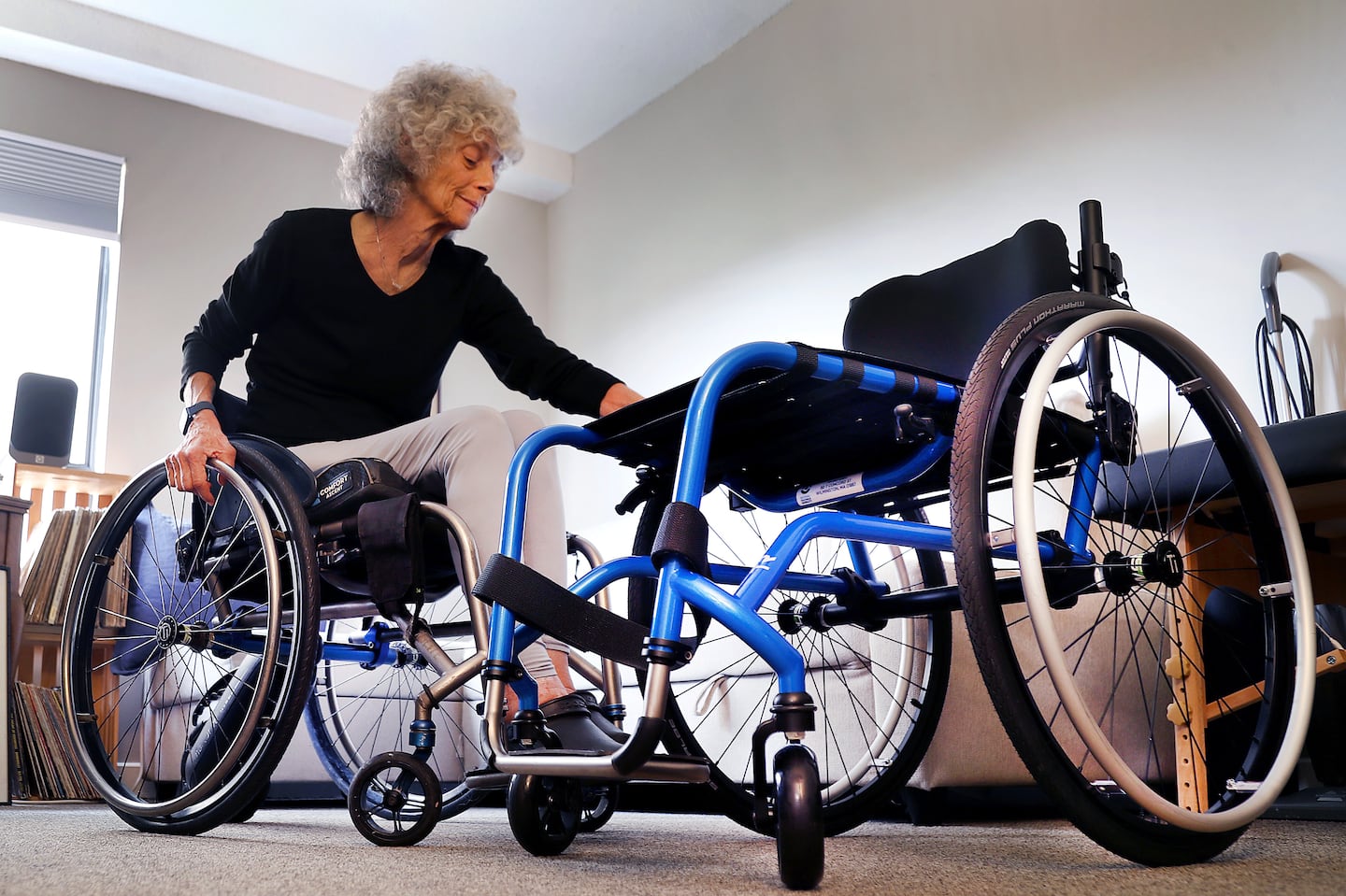 Jackie Miller waited months to get a new wheelchair (right) to replace the 9-year old one she currently uses. When she got it, parts started falling off.