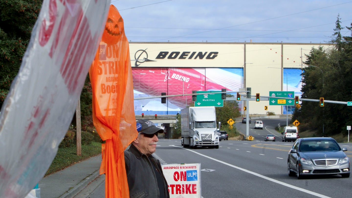 Union machinist Terry Muriekes waves a Halloween-decorated strike sign by Boeing's Everett, Wash., factory on Oct. 22.