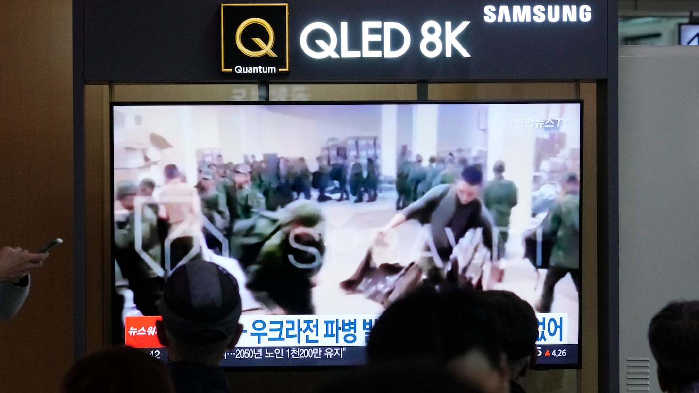 A TV screen shows an image of soldiers believed to be from North Korea stand in line to receive supplies from Russia during a news program at Seoul Railway Station in Seoul, South Korea, Monday, Oct. 21, 2024.