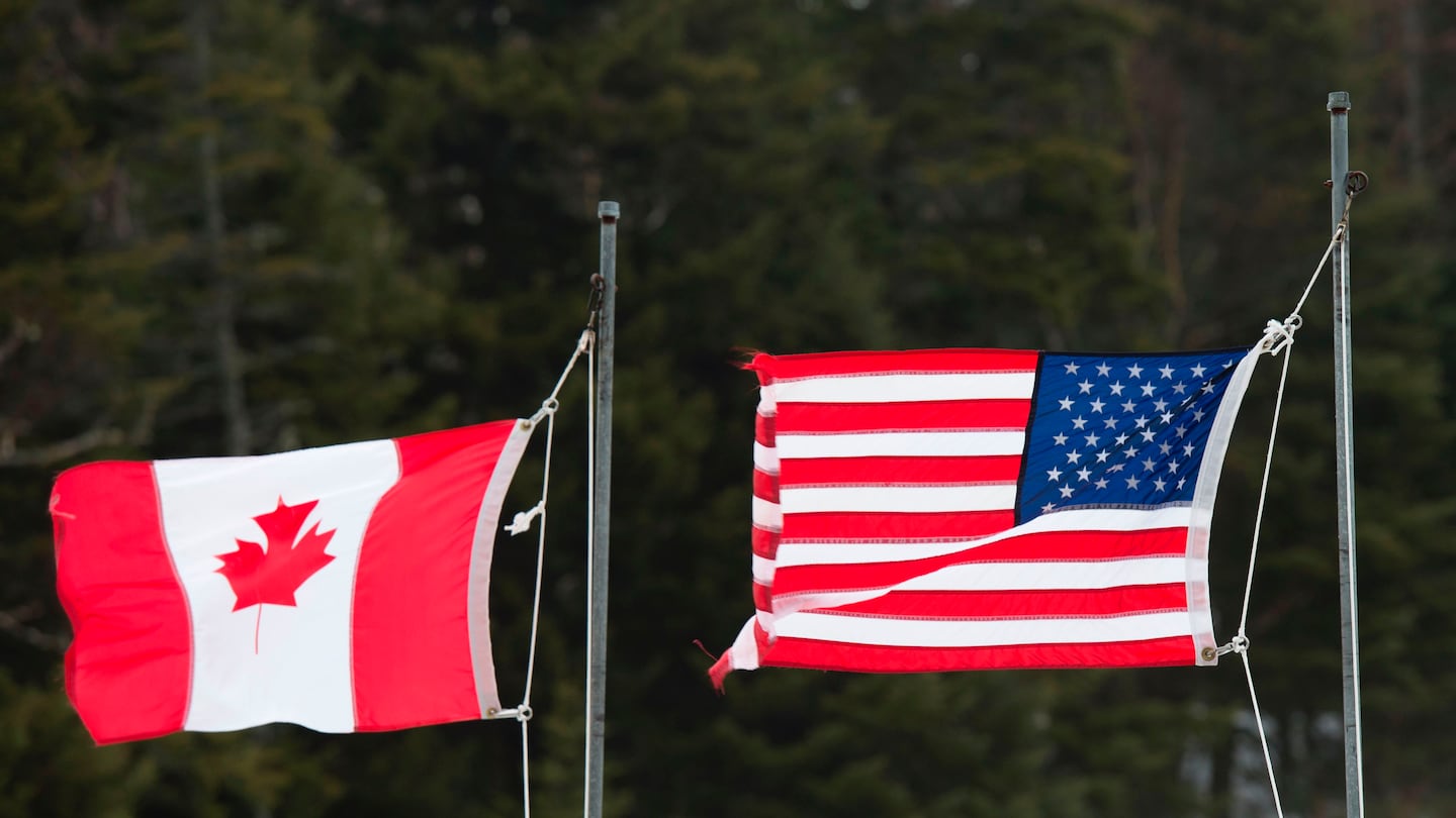 Canadian and American flags wave at the US-Canada border in Pittsburg, N.H.