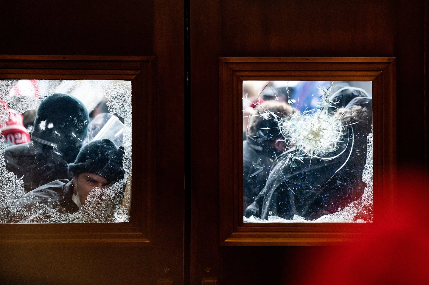 Supporters of then-president Donald Trump broke the glass panes of an entry door and forced their way into the US Capitol in Washington, Jan. 6, 2021. On Oct. 18, 2024, Trump tried to revise the history of the deadly attack on the Capitol by a pro-Trump mob, as new details in the federal prosecution against him were made public by the judge in the case.