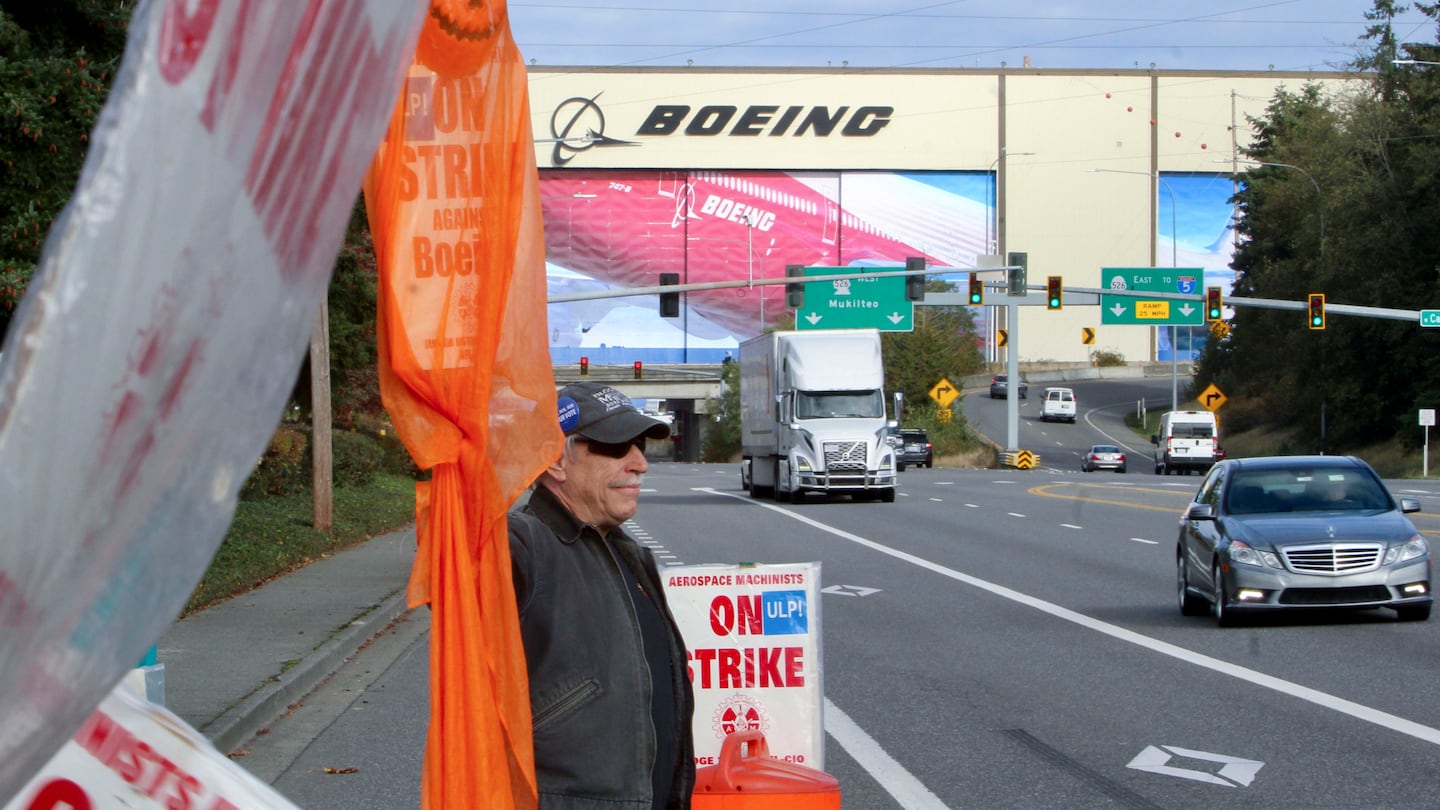 Union machinist Terry Muriekes waves a Halloween-decorated strike sign by Boeing's Everett, Wash., factory on Oct. 22.