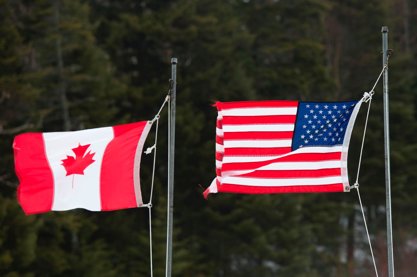 Canadian and American flags wave at the US-Canada border in Pittsburg, N.H.