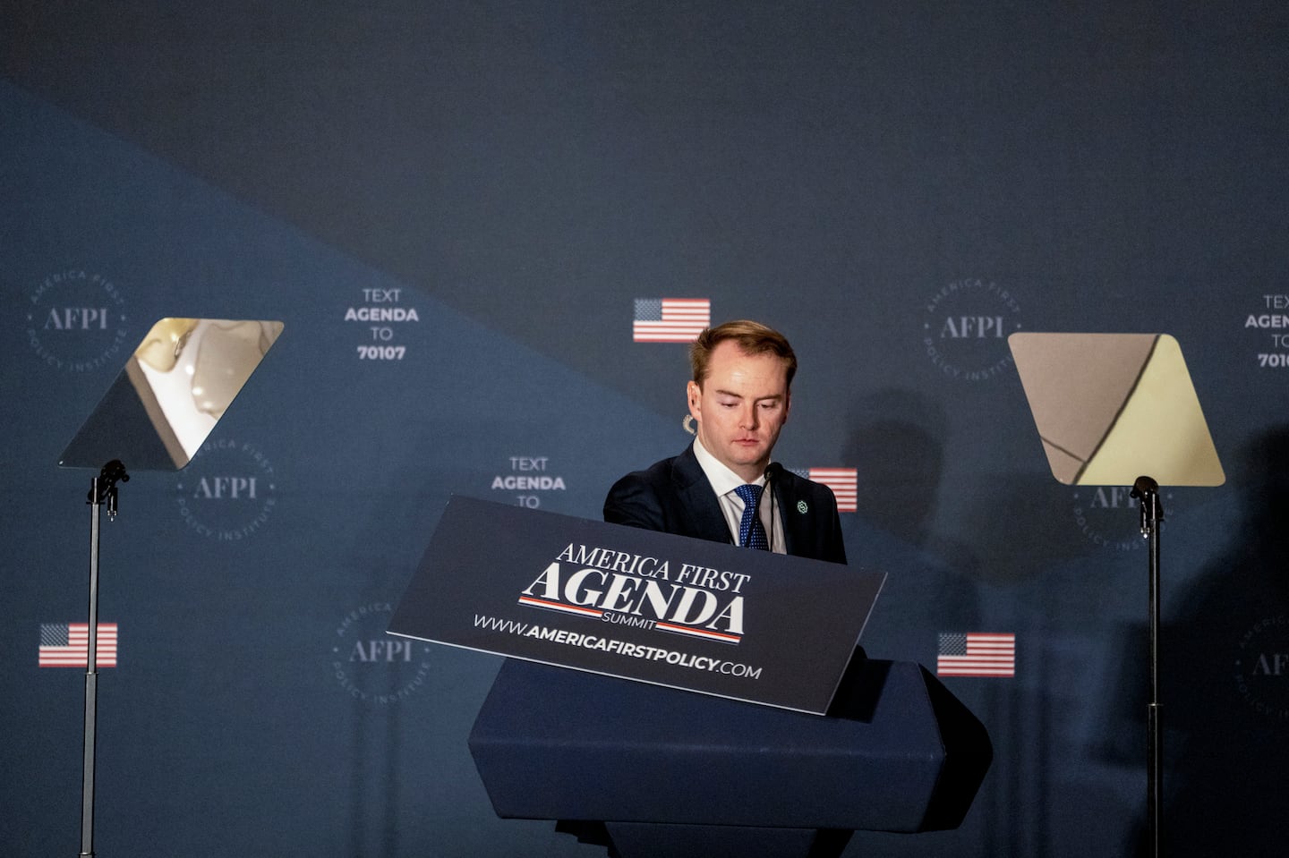 A staffer prepares the lectern before former President Donald Trump gives a keynote speech at the America First Policy Institute Summit in Washington, July 26, 2022.