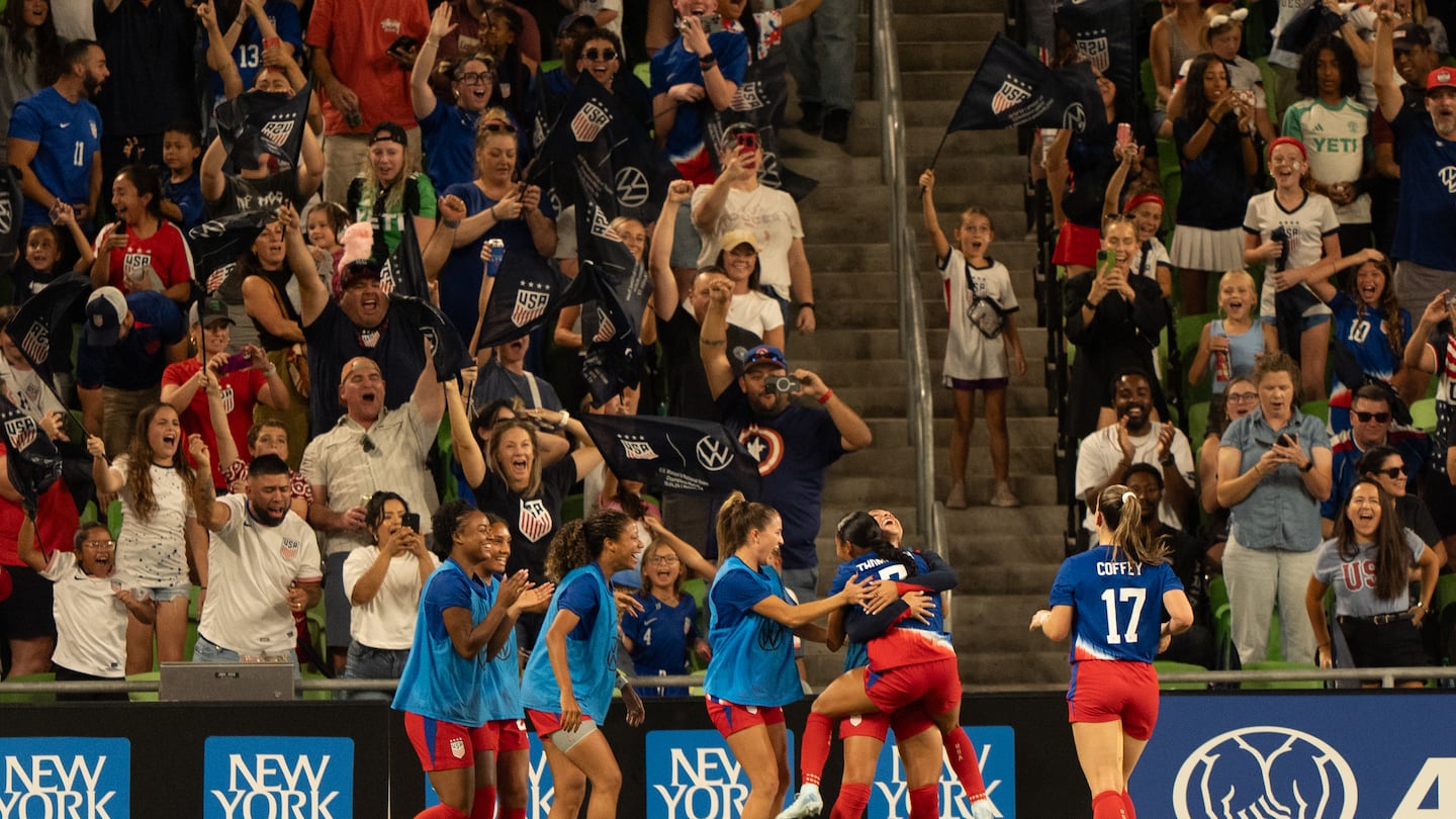 American players mob Alyssa Thompson after the 19-year-old scored her first international goal in Thursday's win over Iceland at Q2 Stadium in Austin, Texas.