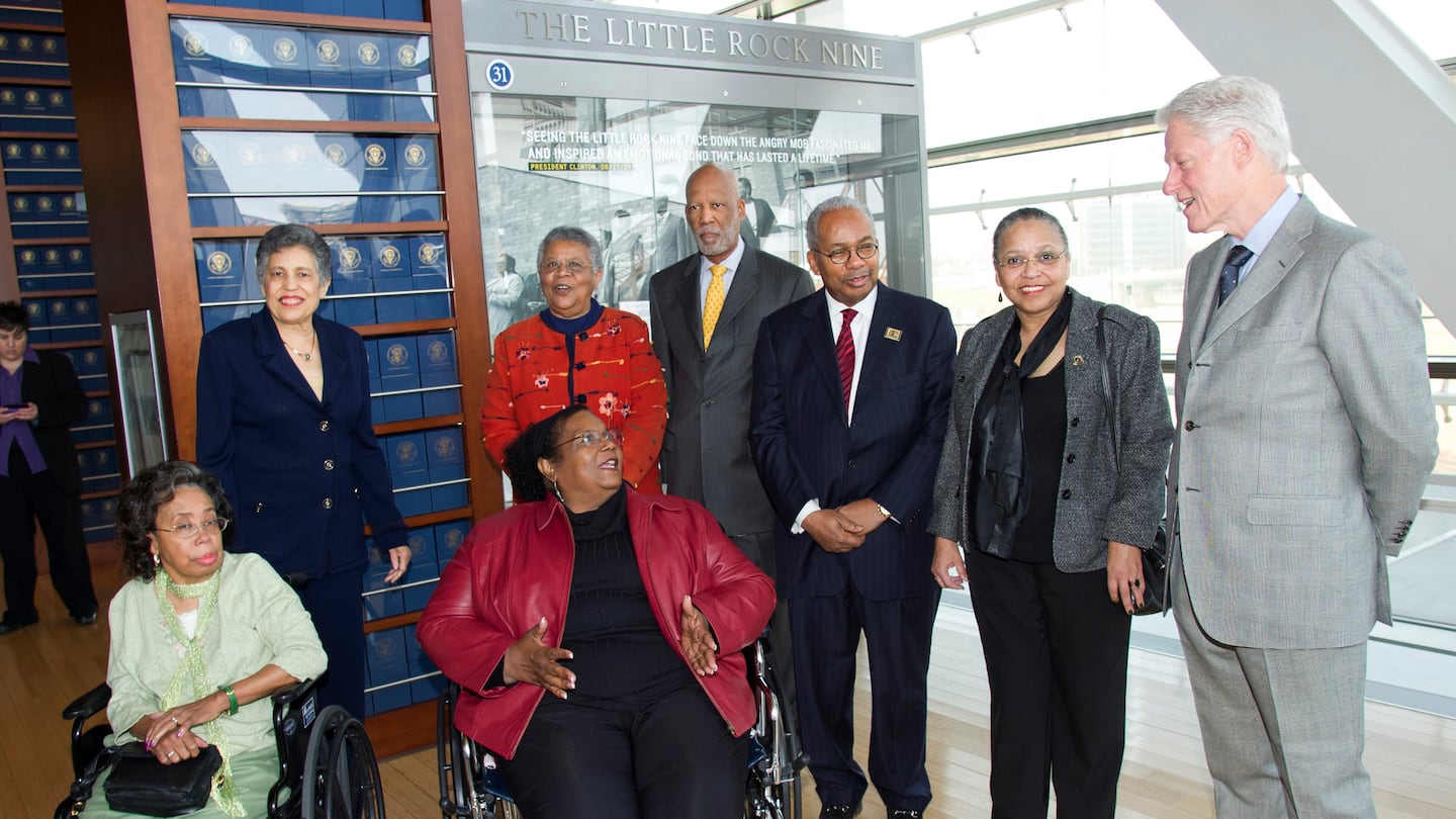 Members of the Little Rock Nine -- standing from left, Carlotta Walls LaNier, Minnijean Brown-Trickey, Terrence Roberts, Ernest Green, Gloria Ray Karlmark, and foreground seated, Ms. Mothershed Wair and Melba Pattillo Beals -- met with former president Clinton at the William J. Clinton Presidential Library in Little Rock in 2011.