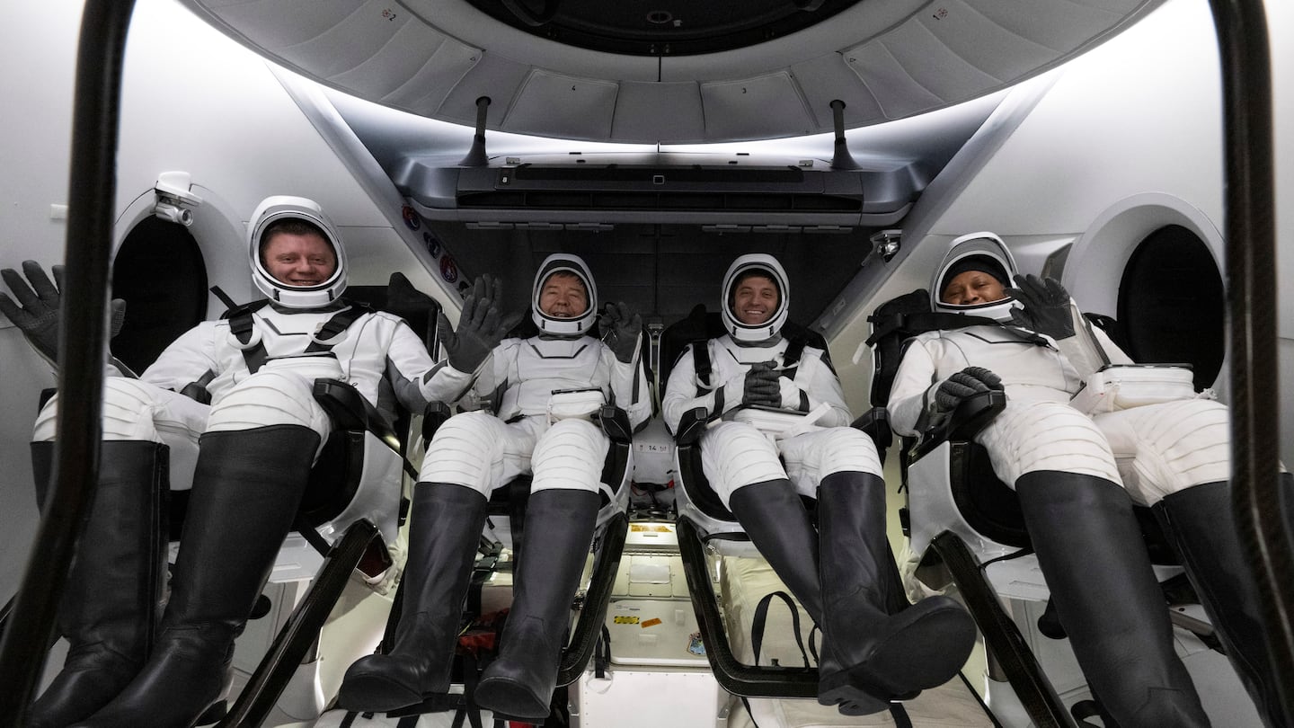 Roscosmos cosmonaut Alexander Grebenkin, left, NASA astronauts Michael Barratt, second from left, Matthew Dominick, second from right, and Jeanette Epps, right, inside the SpaceX Dragon Endeavour spacecraft onboard the SpaceX recovery ship MEGAN shortly after having landed in the Gulf of Mexico off the coast of Pensacola, Florida, on Oct. 25.