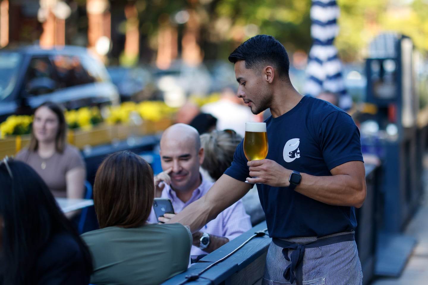 A server brought a beer to a table at Little Whale Oyster Bar in Back Bay on Oct. 6, 2022.