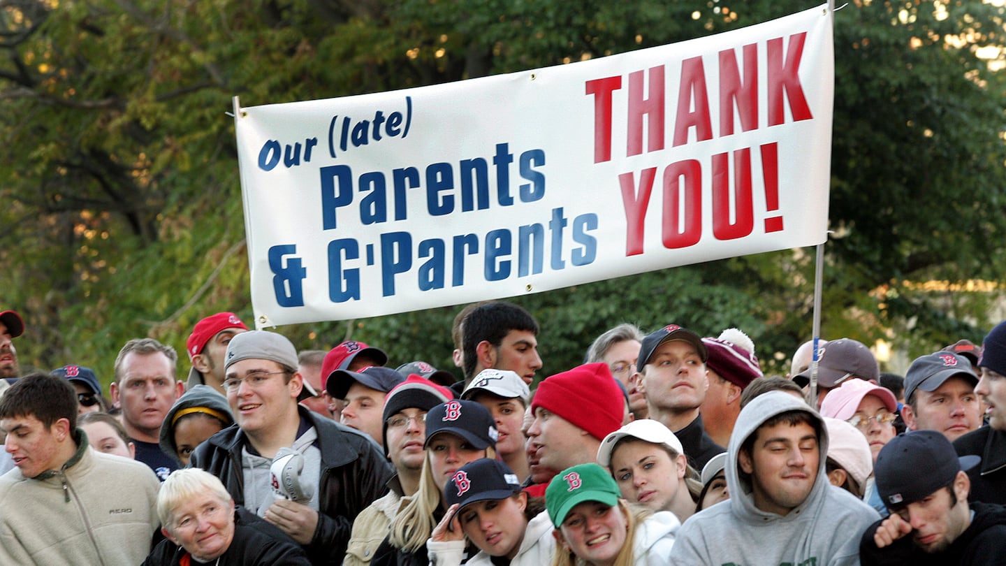 Fans gather near Fenway Park awaiting the arrival of the Red Sox after their overnight flight from St. Louis after winning the World Series.