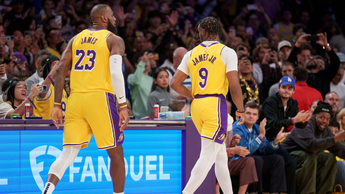 Lakers forward LeBron James (left) and guard Bronny James checked in to become the first father-son duo to play together in the NBA.