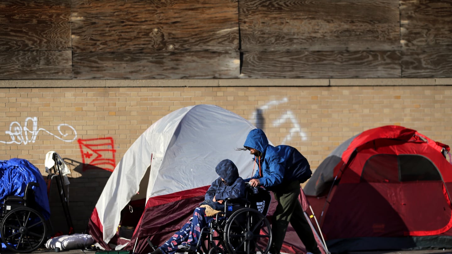 People walked by tents lined up on Southampton Street near the intersection known as Mass. and Cass in Boston in 2021.