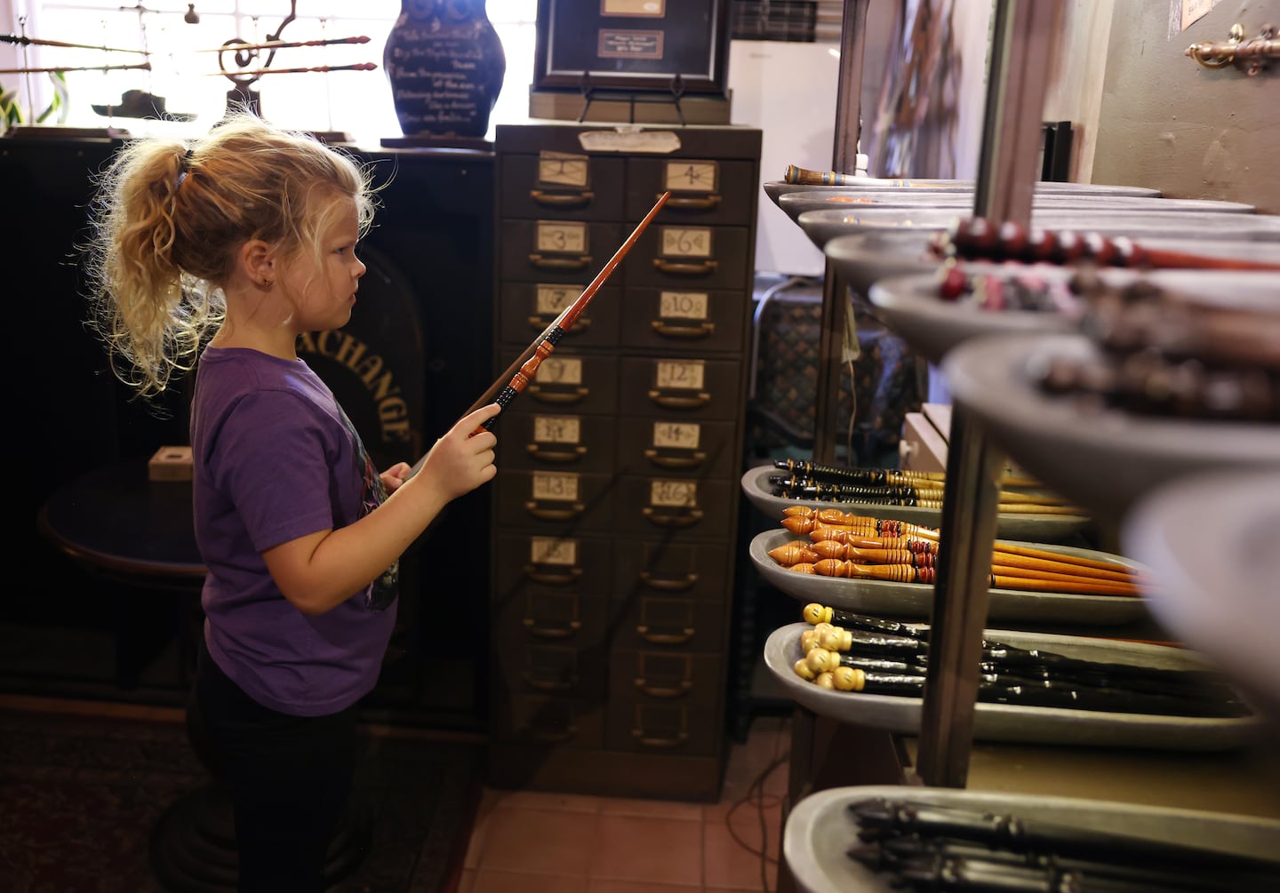 Dylan Hall, 7, of Louisville, Ky., tried to decide between two different wands inside Wynott’s Wands in Salem.