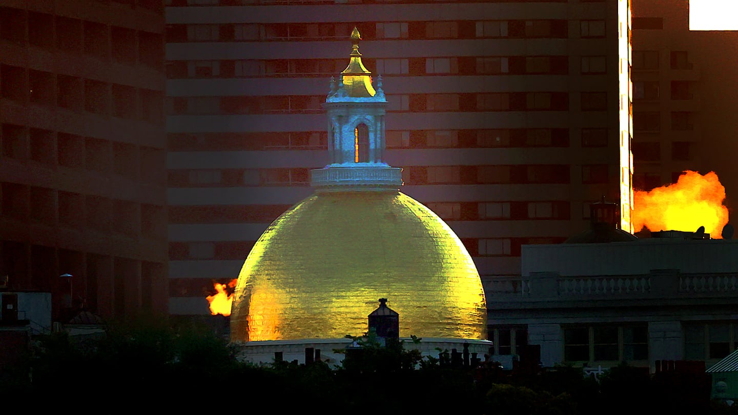 The Massachusetts State House and steam backlit by the morning sunrise on Oct. 4, 2024.