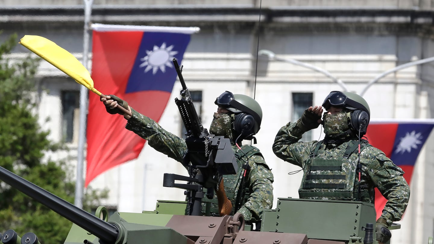 Taiwanese soldiers salute during National Day celebrations in front of the Presidential Building in Taipei, Taiwan, on Oct. 10, 2021.