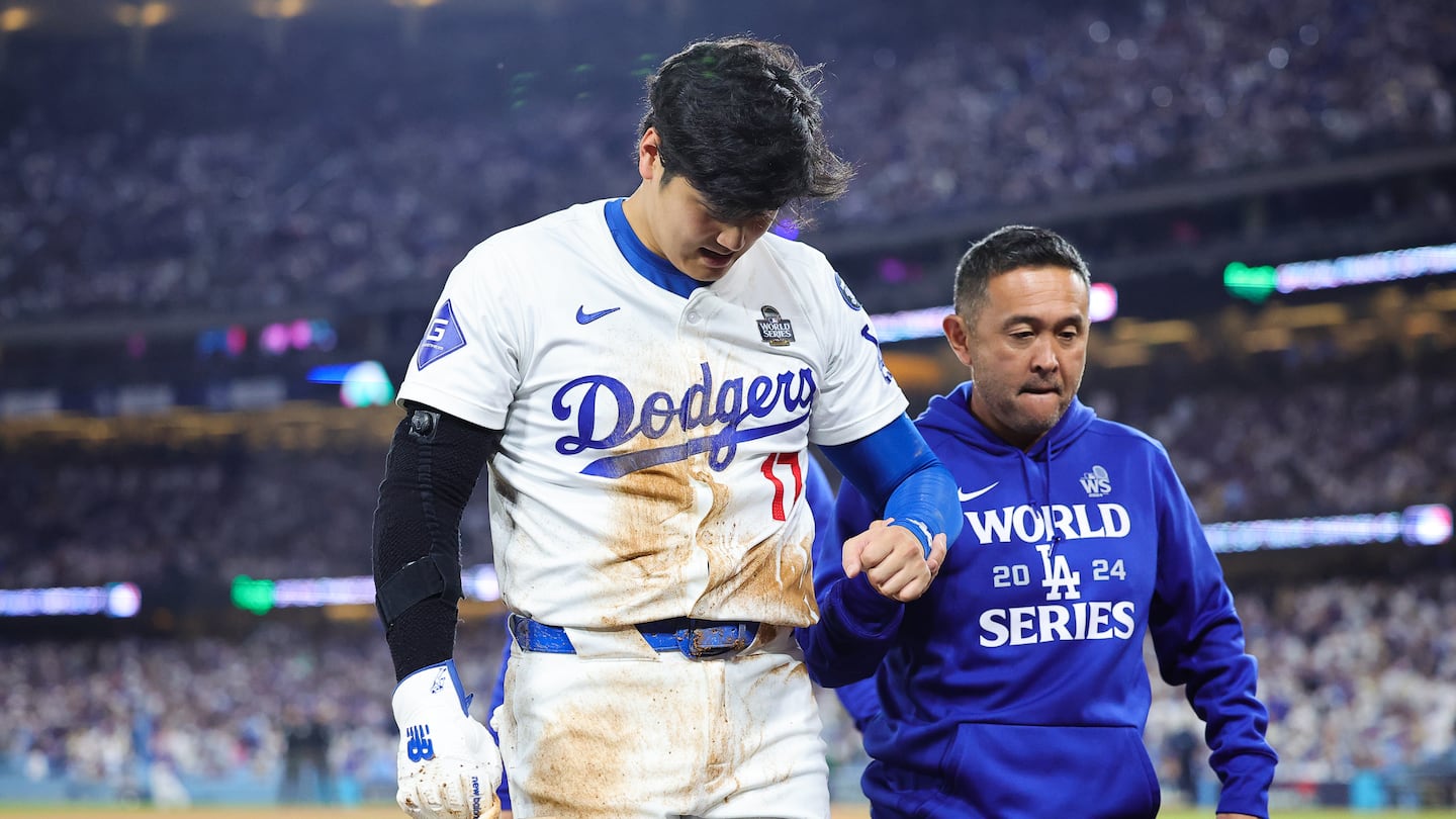 Shohei Ohtani grabbed at his left arm after getting caught trying to steal second base on Saturday night.