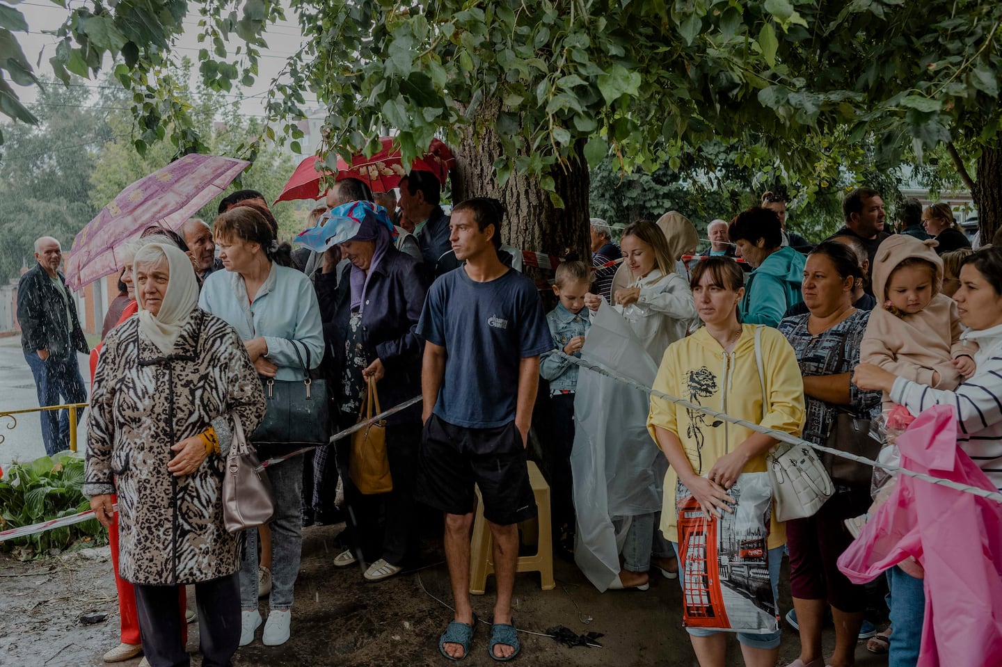 Russians who evacuated from border regions targeted by Ukraine’s military wait for a distribution of aid in Kursk, Russia, on Aug. 13.