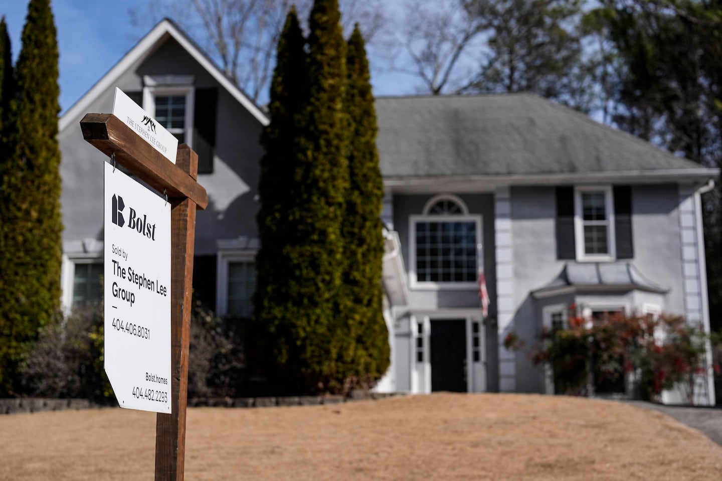 A sign announcing a home for sale is posted outside a home Feb. 1, 2024, in Kennesaw, Ga., near Atlanta.