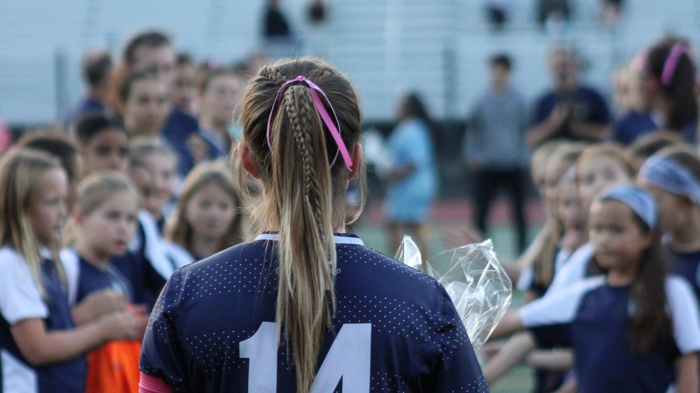 Senior captain Ana Sheedy stands before a tunnel of youth soccer players as she prepares to run out to meet her parents for Medway's senior night ceremony Oct. 22, 2024, prior to a 4-0 win over visiting Bellingham.