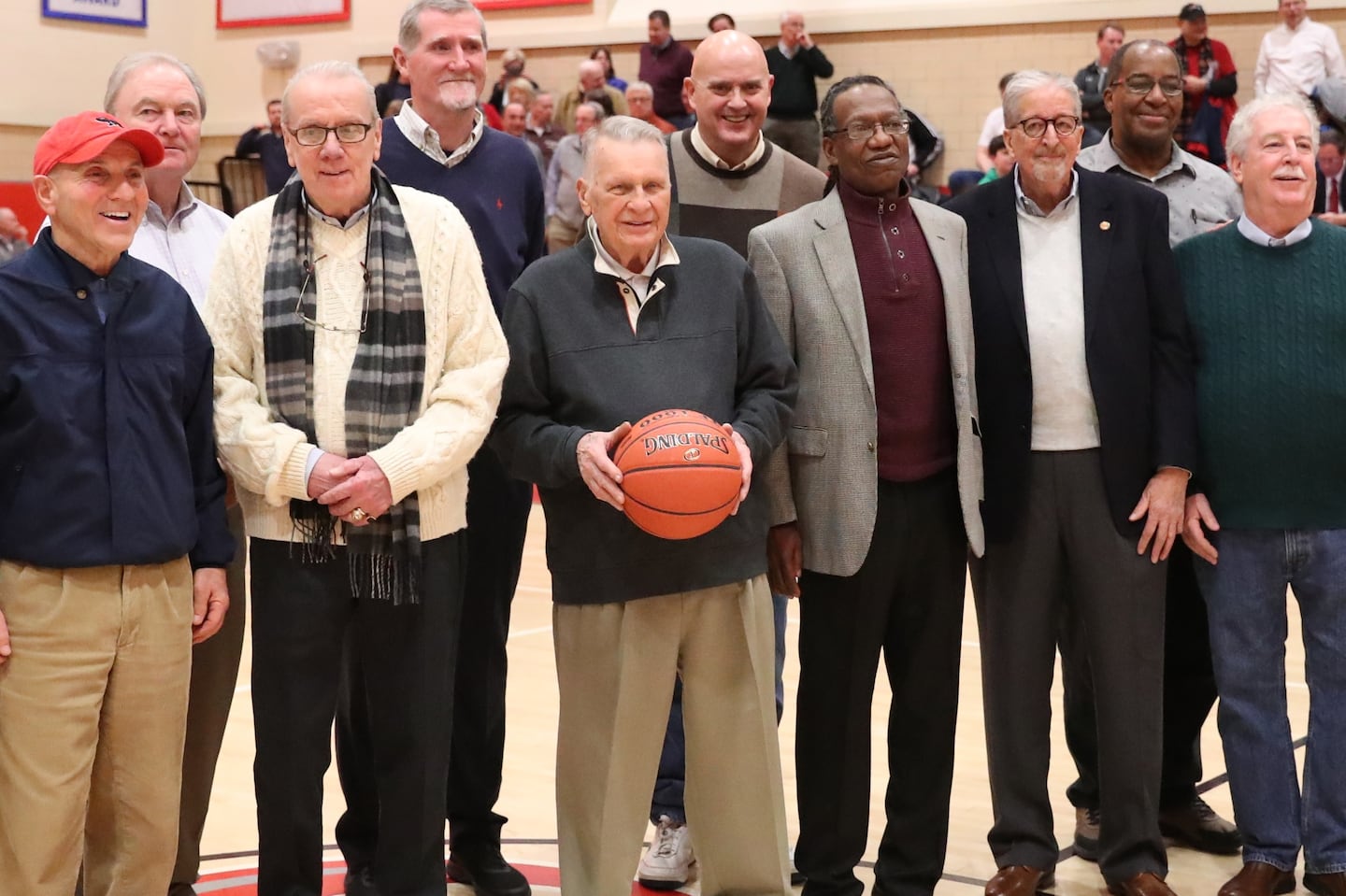 Ron Perry Sr. (center) is shown in 2019 at Catholic Memorial at an anniversary celebration for his 1969 team that went 29-0.