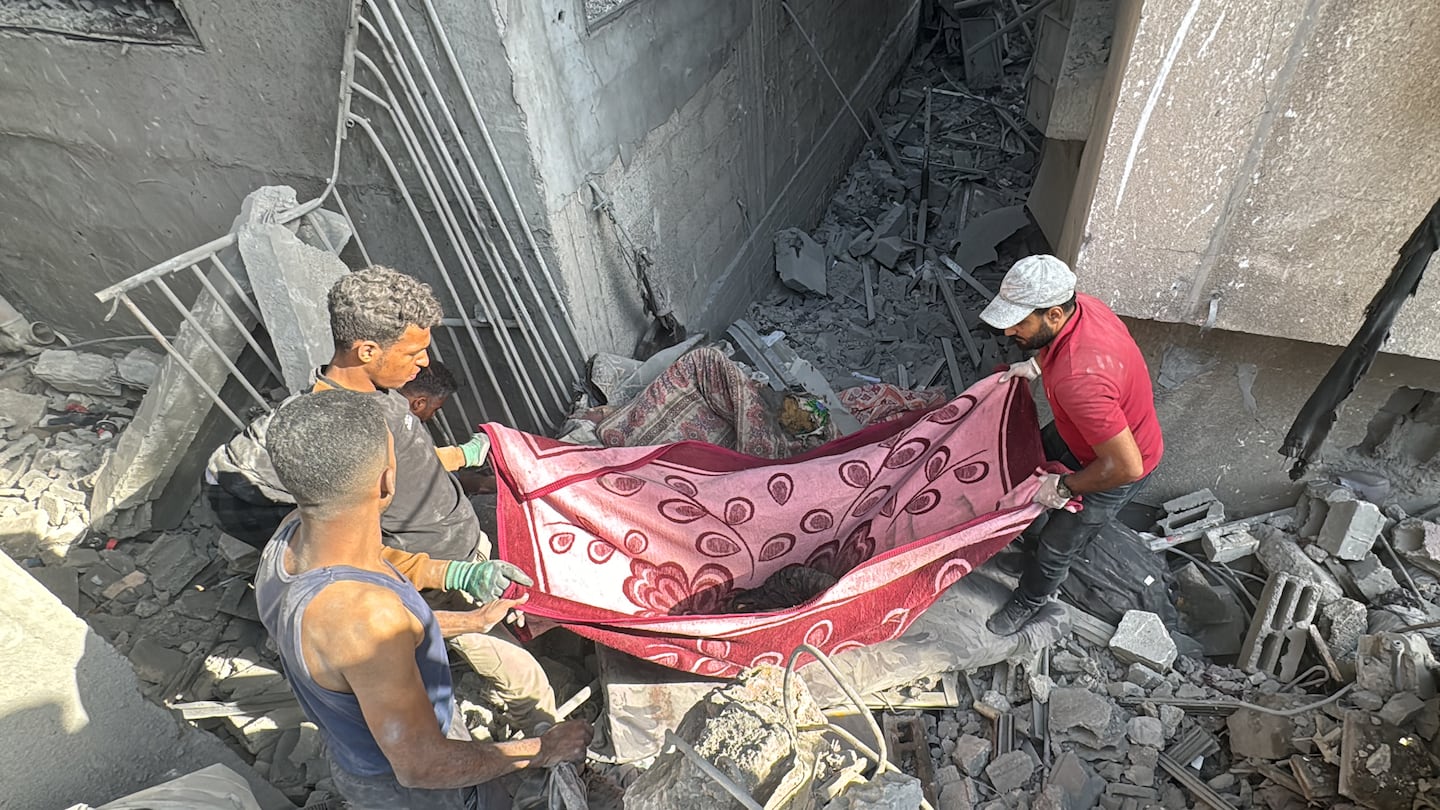 Palestinians removed a body from the rubble of a building hit by an Israeli strike in Beit Lahia, in the northern Gaza Strip, on Monday.