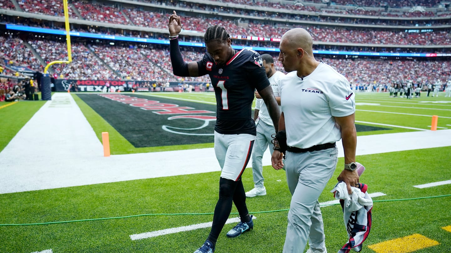 Texans wide receiver Stefon Diggs waves to fans as he walks off the field after getting injured during the second half against Indianapolis on Sunday in Houston. 