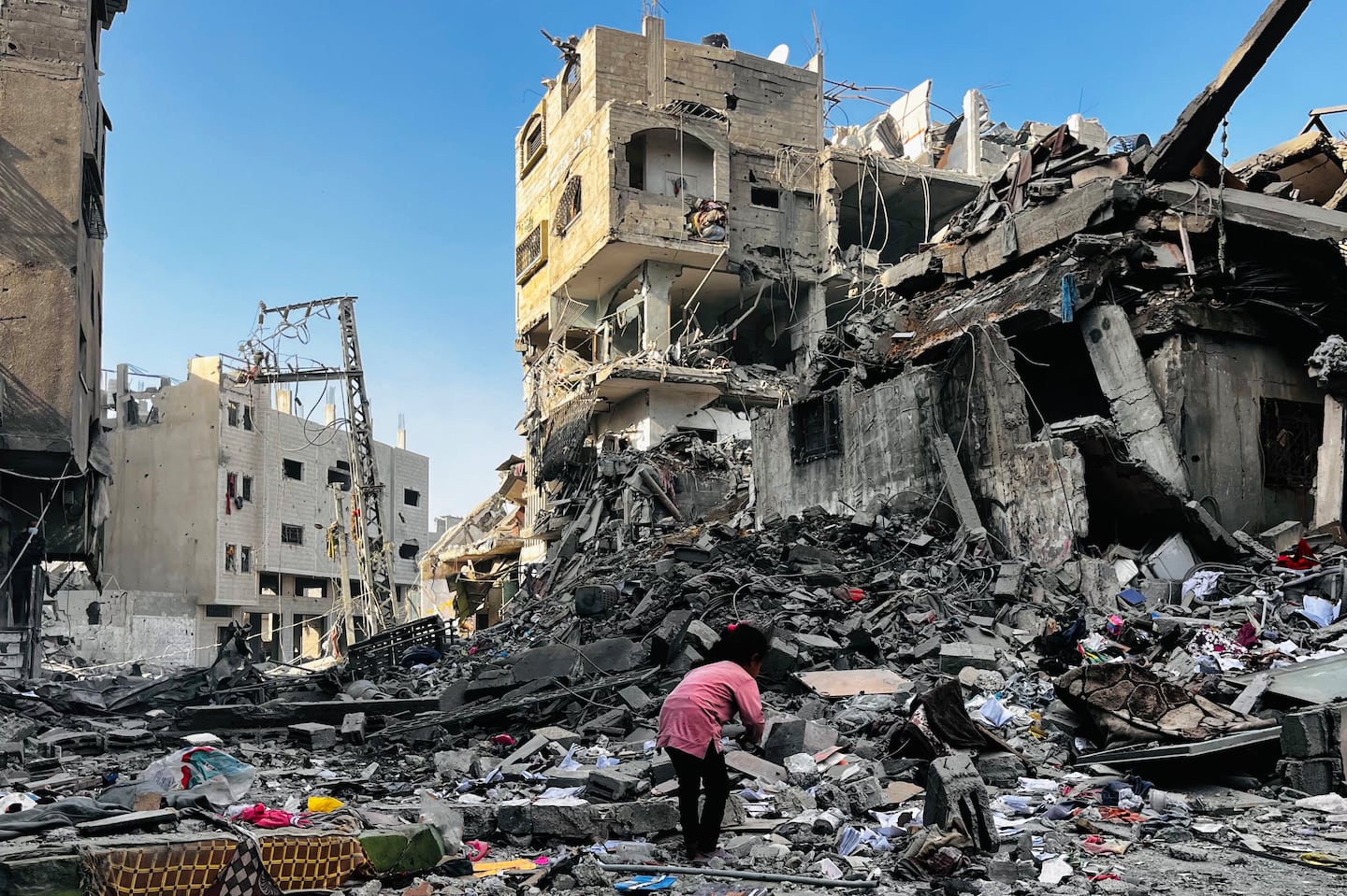 A Palestinian girl inspects the rubble of a building after an Israeli strike in Beit Lahia, in the northern Gaza Strip, on Oct. 29.