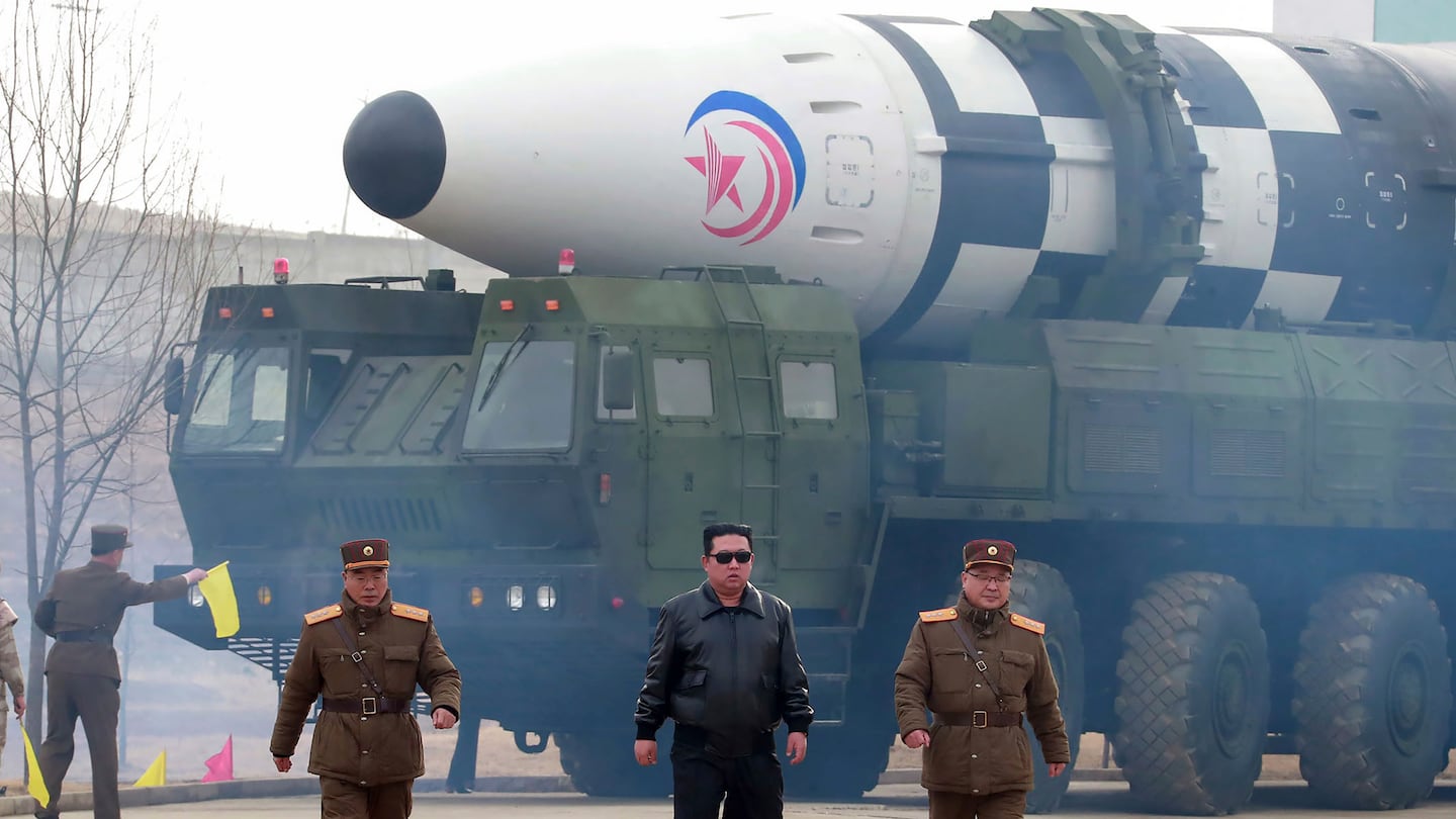 North Korean leader Kim Jong Un walks near what it says is a Hwasong-17 intercontinental ballistic missile (ICBM) on the launcher in North Korea on March 24, 2022.