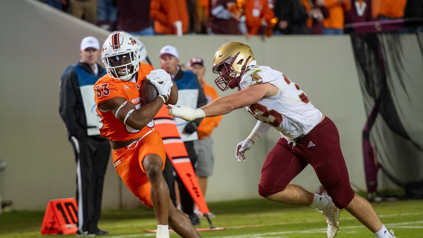 Virginia Tech's Bhayshul Tuten (left) scored four touchdowns against BC, including one on an 83-yard run.