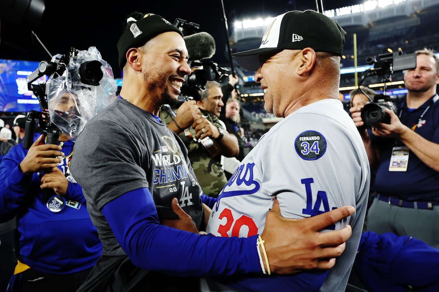 Manager Dave Roberts #30 of the Los Angeles Dodgers celebrates with Mookie Betts #50 after the Dodgers defeated the New York Yankees 7-6 in Game Five to win the 2024 World Series at Yankee Stadium on October 30, 2024 in the Bronx borough of New York City. (Photo by Sarah Stier/Getty Images)