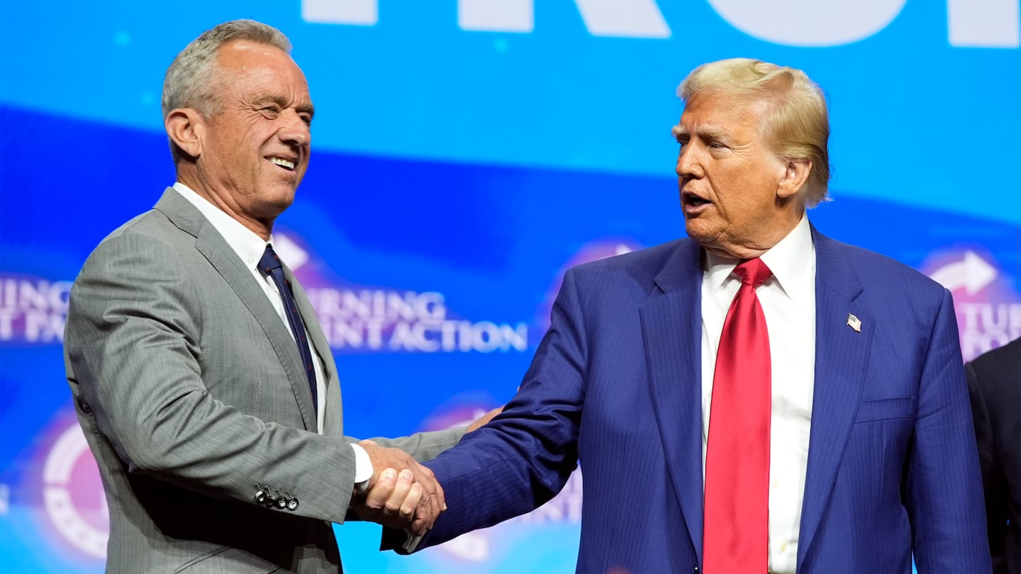 Republican presidential nominee former president Donald Trump shakes hands with Robert F. Kennedy Jr. at an October campaign rally in Duluth, Ga.