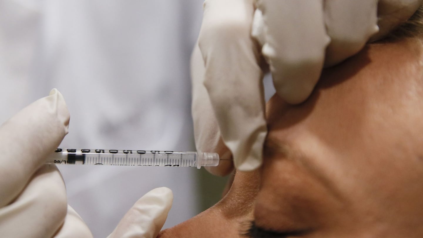 A doctor in Redondo Beach, Calif., injects Botox between a patient's eyes. Federal prosecutors allege that the owner of a Massachusetts spa chain injected hundreds of patients with counterfeit Botox and other cosmetic products while posing as a nurse.