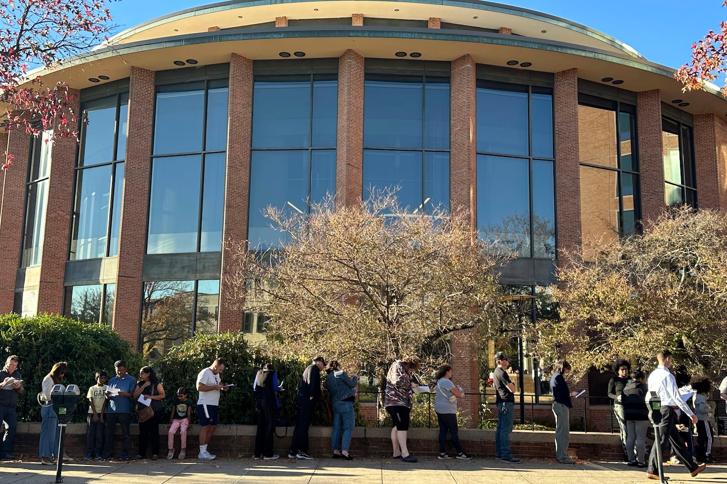 Voters line up outside the Bucks County Administration Building during early voting in the general election, Friday, Nov. 1, 2024, in Doylestown, Pa.