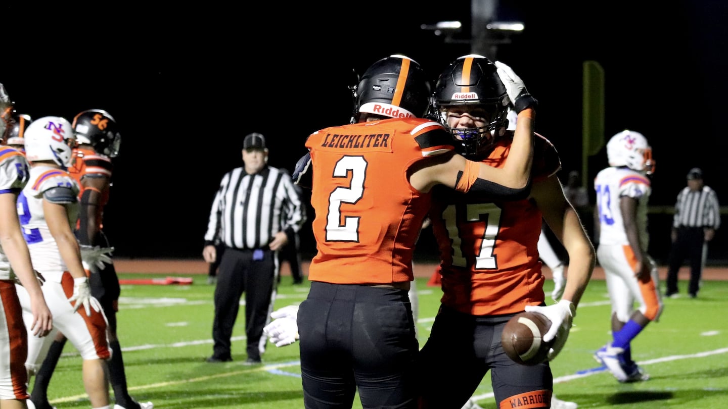 Wayland seniors Braden Leichliter (No. 2) and Jamie Buffum (No. 17) celebrate after a play during a 62-20 win against visiting Newton South on Friday night.