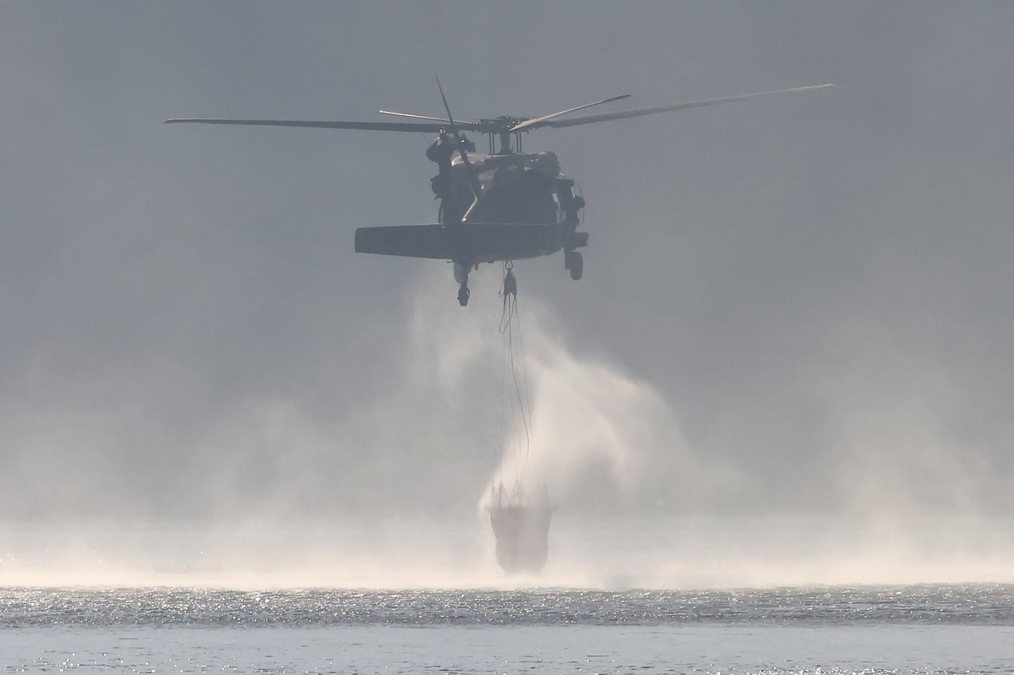 The Massachusetts Army National Guard assisted with a brush fire in the woods surrounding Middleton Pond.