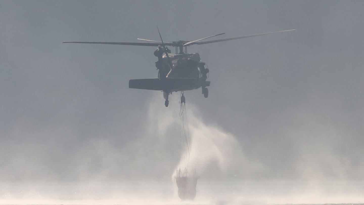 The Massachusetts Army National Guard assisted with a brush fire in the woods surrounding Middleton Pond.