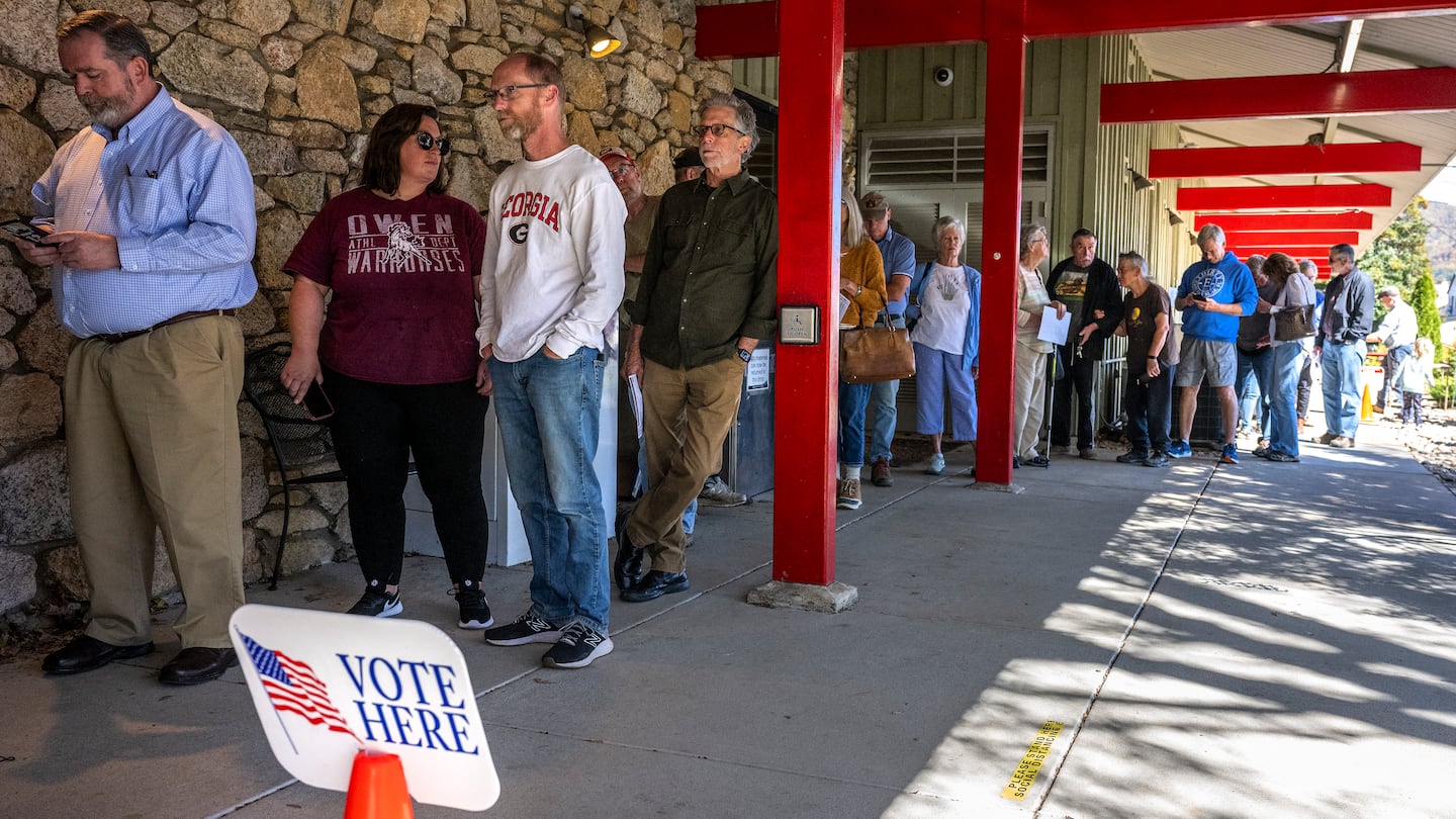 People line up for early voting at a polling station at the Black Mountain Public Library in Black Mountain, N.C., on Oct. 21.