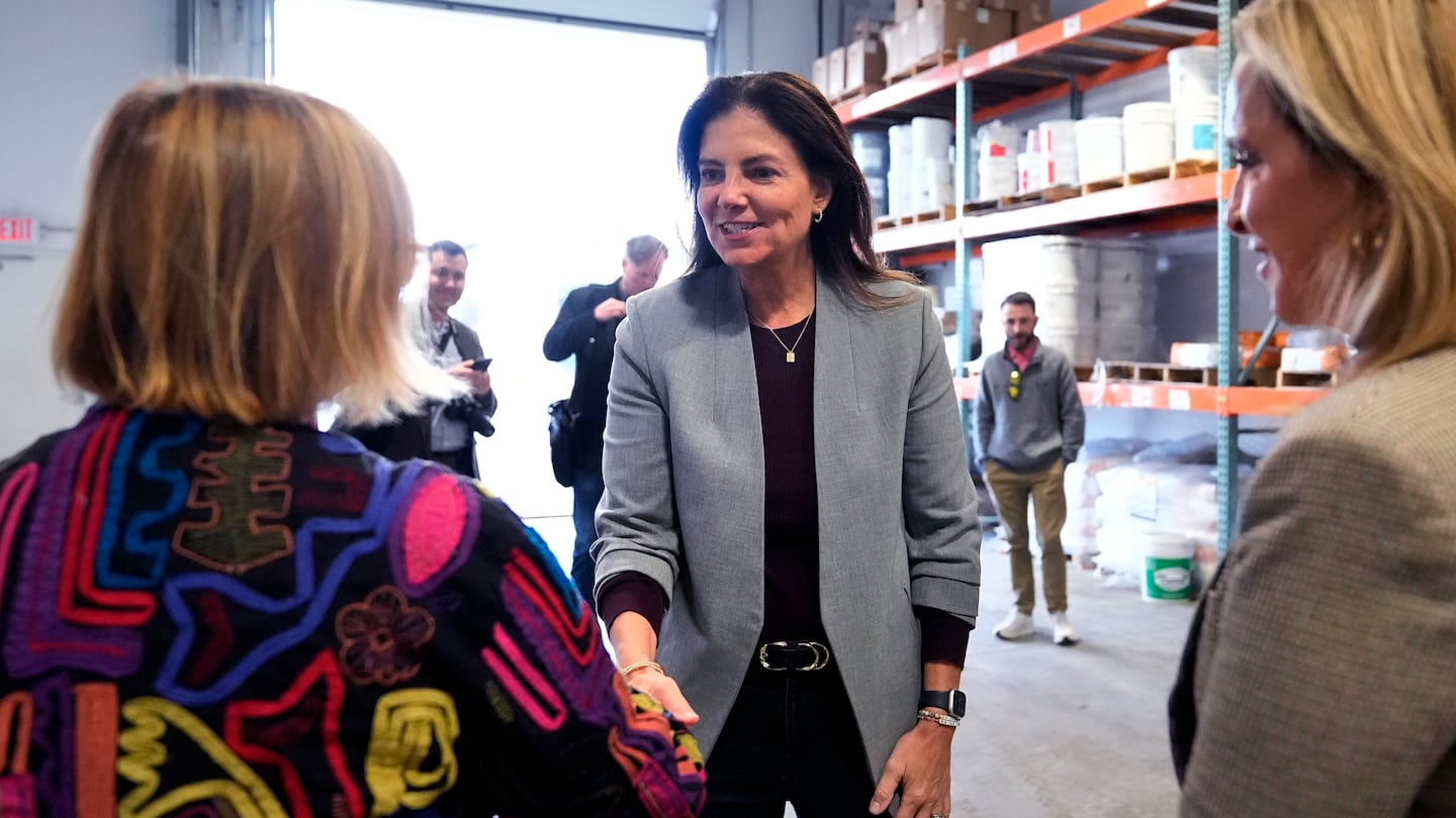 Republican gubernatorial candidate Kelly Ayotte, who faces Democrat Joyce Craig in the November 2024 election, shakes hands with administrators during a visit to a local concrete coating business, Wednesday, Oct. 16, 2024, in Manchester, N.H.