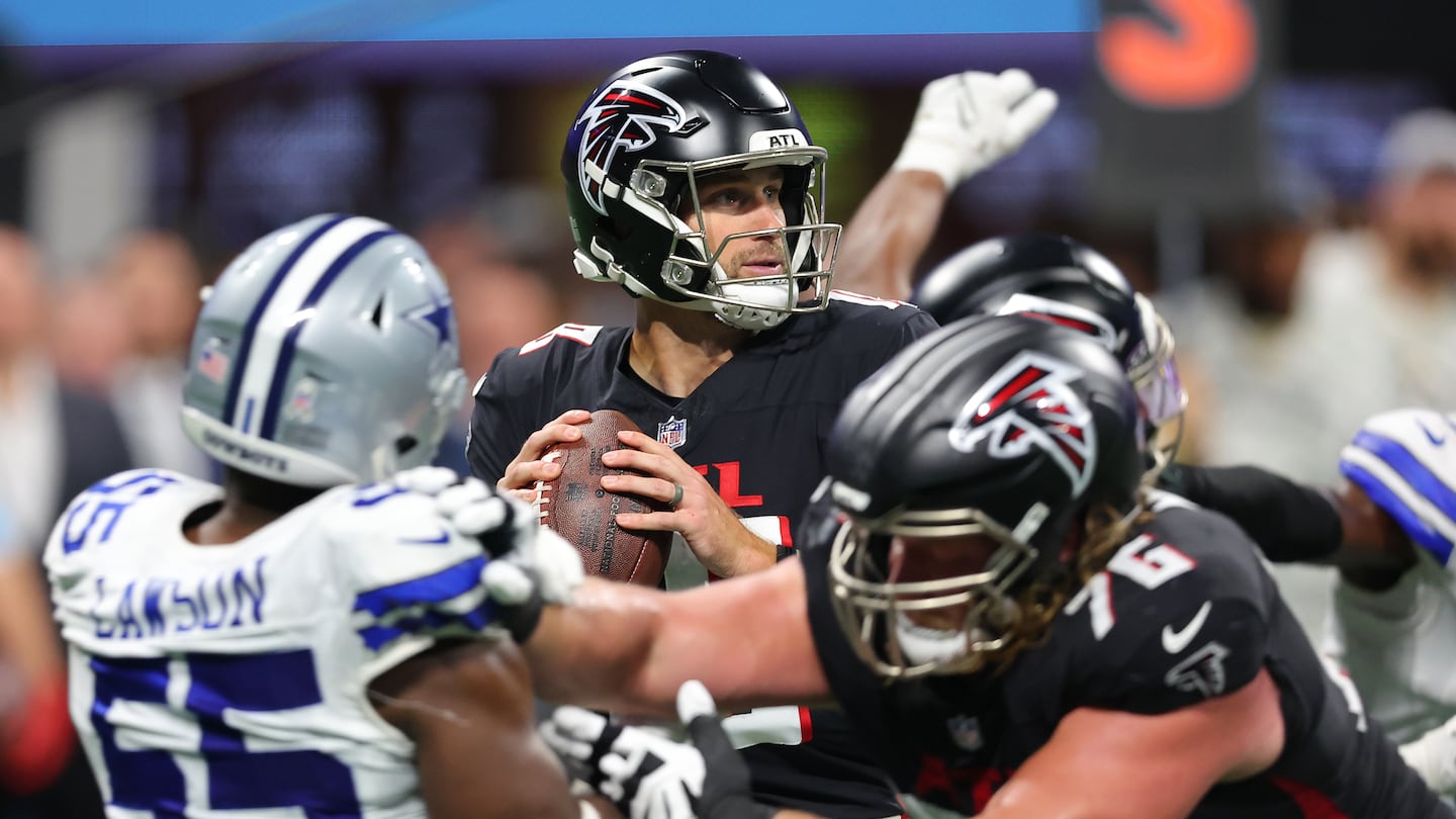 Falcons quarterback  Kirk Cousins, who threw for three touchdowns, steps back to pass during the third quarter against the Cowboys.