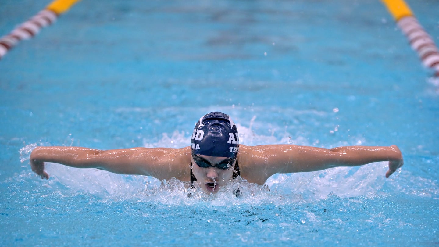 Acton-Boxborough senior star Isabela Teixeira powers her way to victory in the 100-yard butterfly at the North sectional championships Sunday at MIT's Zesiger Sports & Fitness Center.