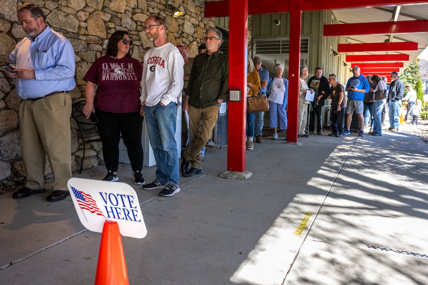 People line up for early voting at a polling station at the Black Mountain Public Library in Black Mountain, N.C., on Oct. 21.