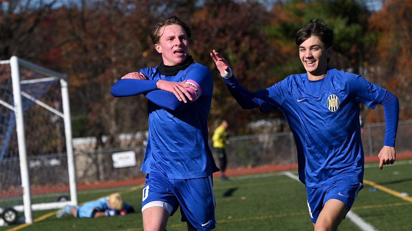 Acton-Boxborough senior captain Will McKnight (left) celebrates with Samuel Ali after burying a penalty kick, giving the host Revolution the lead against North Andover in a Division 1 preliminary-round win Sunday. 