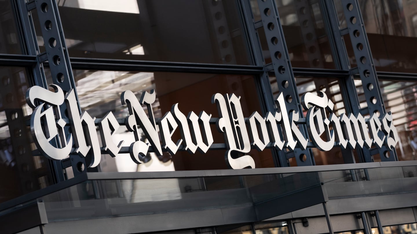 A sign for The New York Times hangs above the entrance to its building on May 6, 2021.