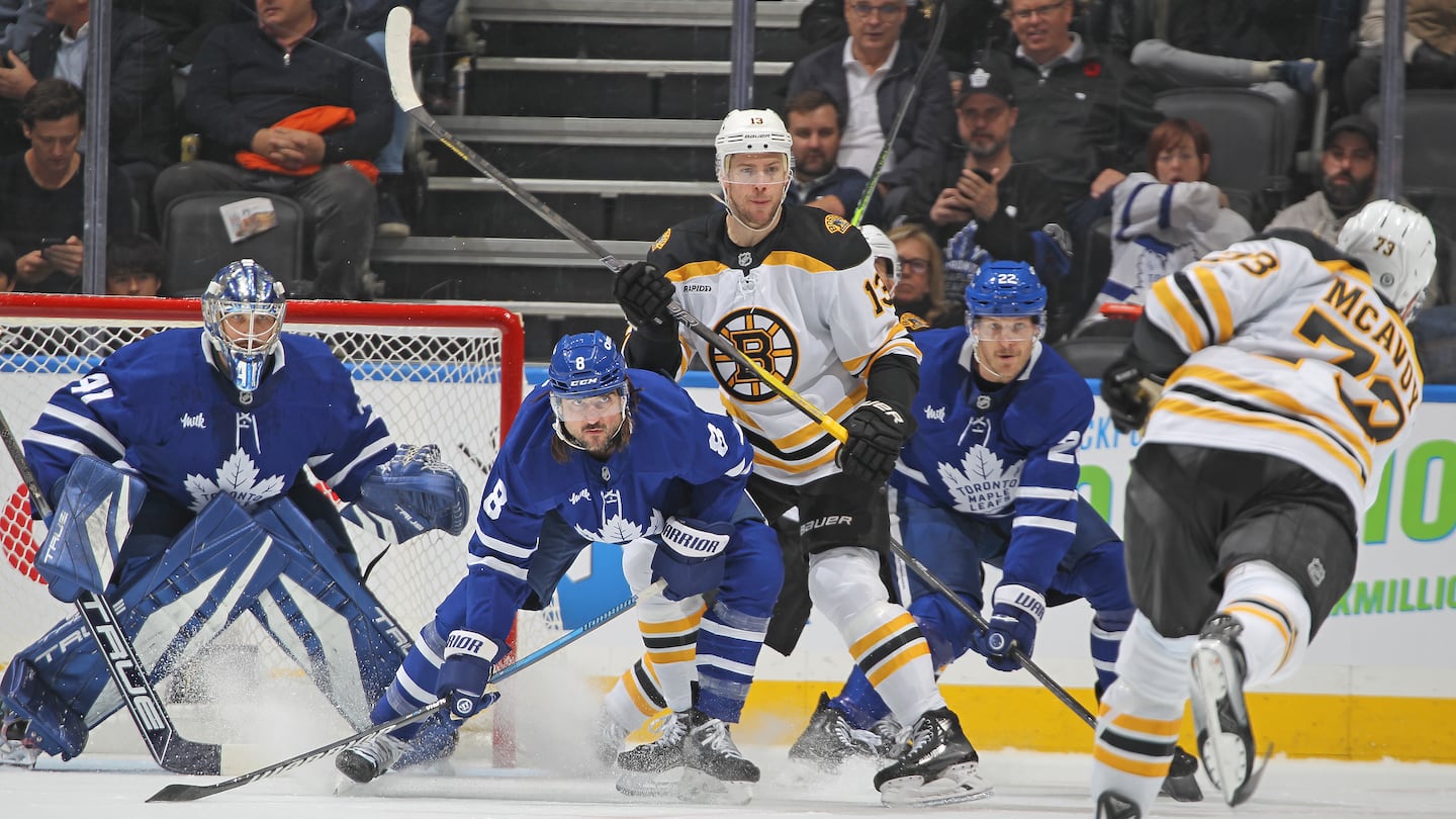 Maple Leafs goalie Anthony Stolarz (left) had to look around a screen set by the Bruins' Charlie Coyle (center) to track a Charlie McAvoy bid from high above the circle.