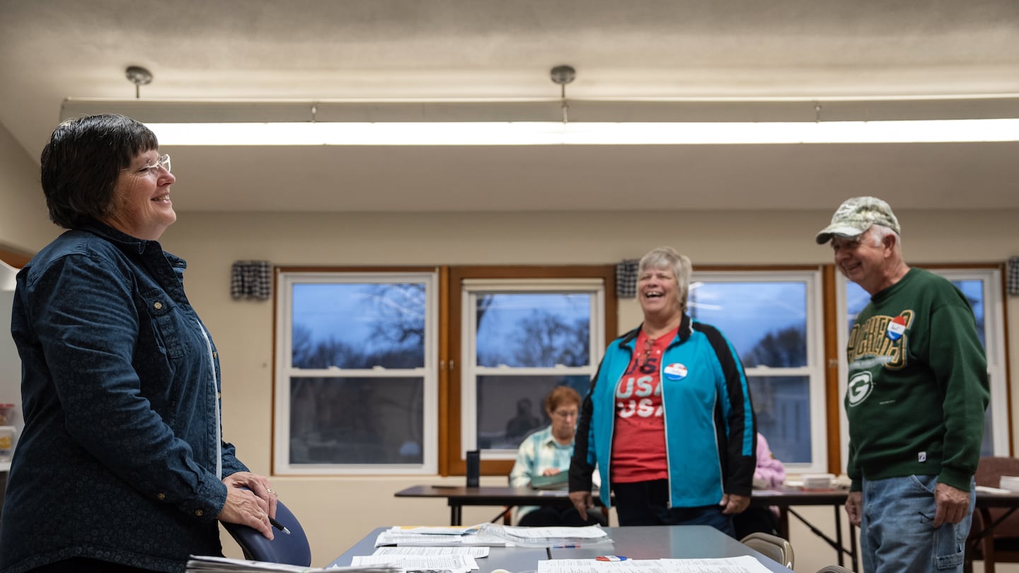 Graceanne Toberman (left), the municipal clerk of Magnolia, Wis., spoke with voters on Election Day, Tuesday. Toberman said she knows about 90 percent of the people who walk through the door to vote on Election Day.