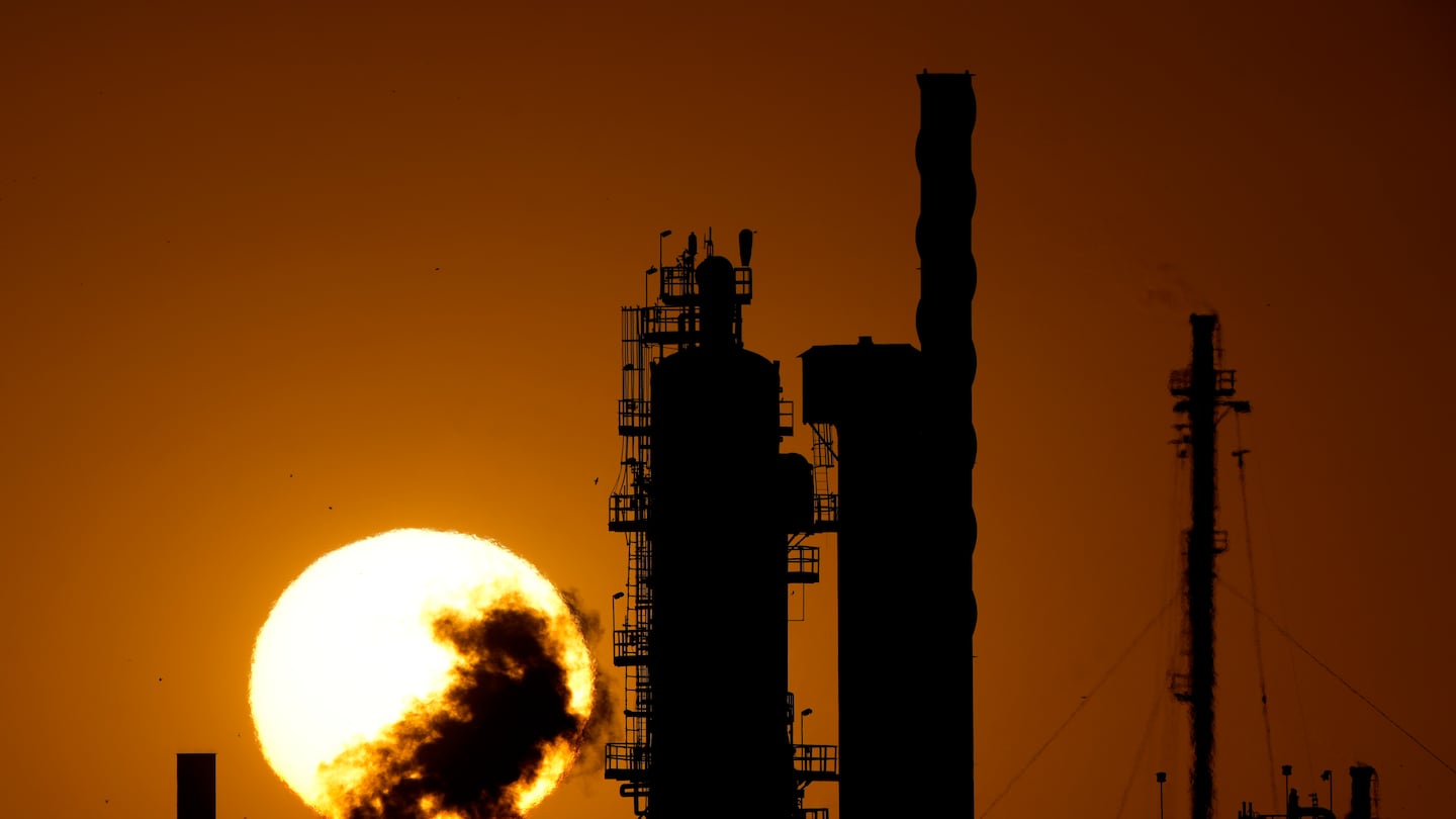 The CHS oil refinery was silhouetted against the setting sun in late September in McPherson, Kan.