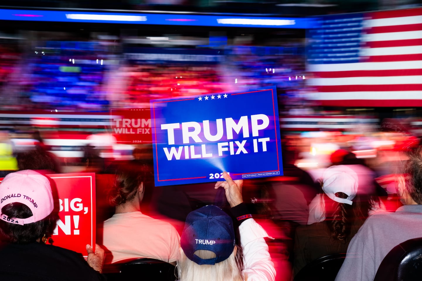 Attendees held signs at a campaign event for Trump in Greensboro, N.C., on Saturday.