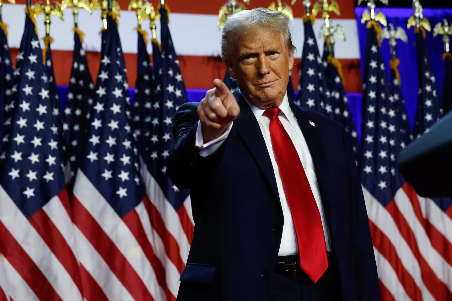 Republican presidential nominee former president Donald Trump waves as he walks with former first lady Melania Trump at an election night watch party at the Palm Beach Convention Center, Wednesday, Nov. 6, 2024, in West Palm Beach, Fla.